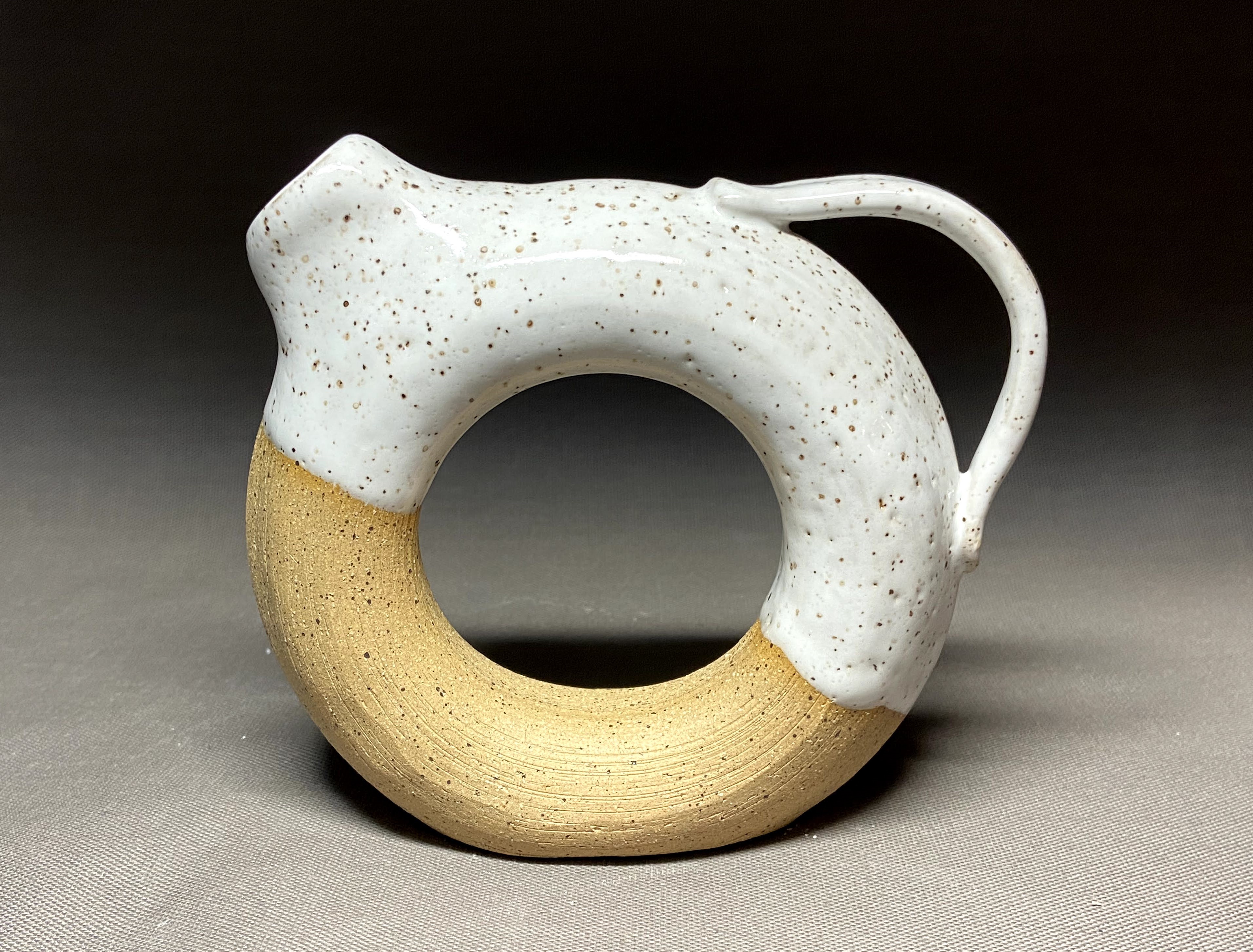 Speckled handmade ceramic vase with a rounded body by Nerdworks Pottery